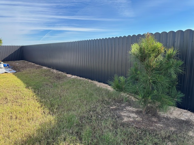Grey steel privacy fence installed in a Houston-area yard