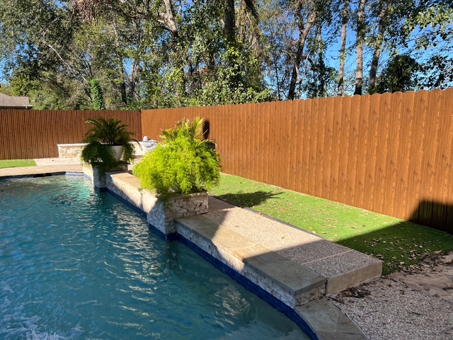 Wood-grain Dura fence pool installation